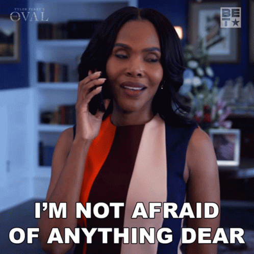 A Woman Talking On A Cell Phone With The Words I 'M Not Afraid Of Anything Dear Below Her GIF
