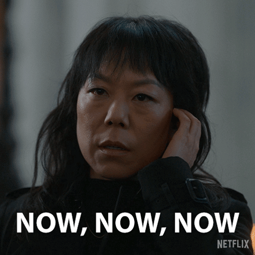 A Woman Talking On A Cell Phone With The Words Now Now Now Written On The Bottom GIF
