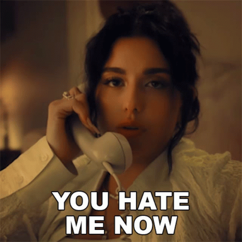 A Woman Talking On A Phone With The Words " You Hate Me Now " Next To Her GIF