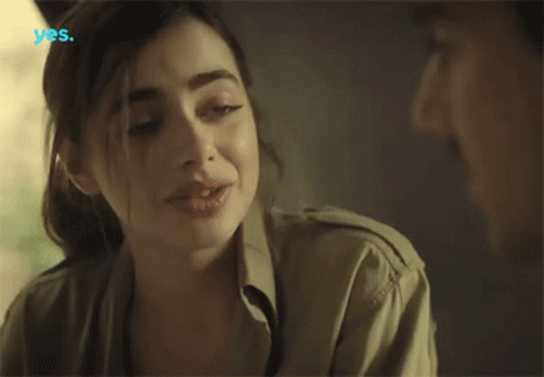 A Woman Talking To A Man With The Word Yes On The Bottom Left GIF