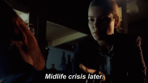 A Woman Talking To A Man With The Words Midlife Crisis Later GIF