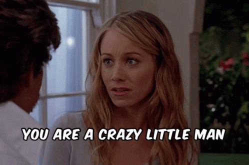 A Woman Talking To A Man With The Words You Are A Crazy Little Man Below Her GIF