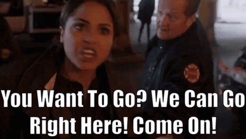 A Woman Talking To A Police Officer With The Words " You Want To Go ? We Can Go Right Here Come On ! " GIF