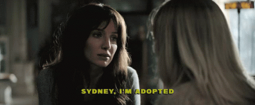 A Woman Talking To Another Woman With The Words Sydney I 'M Adopted Above Her GIF