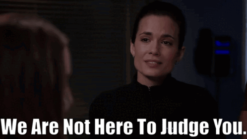 A Woman Talking To Another Woman With The Words " We Are Not Here To Judge You " Below Her GIF