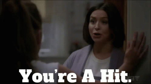 A Woman Talking To Another Woman With The Words " You 'Re A Hit " GIF