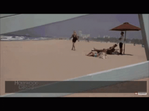 A Woman Walking On A Beach With Hollywood Girls 3 Written On The Bottom GIF