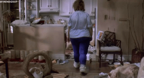 A Woman Walking Through A Messy Kitchen With The Hashtag Trendizisst GIF