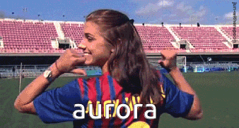 A Woman Wearing A Aurora Jersey Stands In Front Of A Stadium GIF