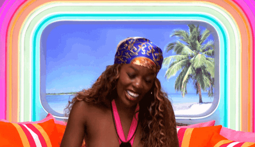 A Woman Wearing A Bandana And A Medal Is Smiling GIF