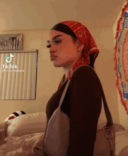 A Woman Wearing A Bandana And A Purse Has A Tiktok Account GIF