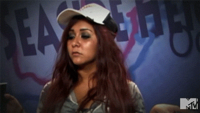 A Woman Wearing A Baseball Cap Is Standing In Front Of A Sign That Says Seas The Day GIF