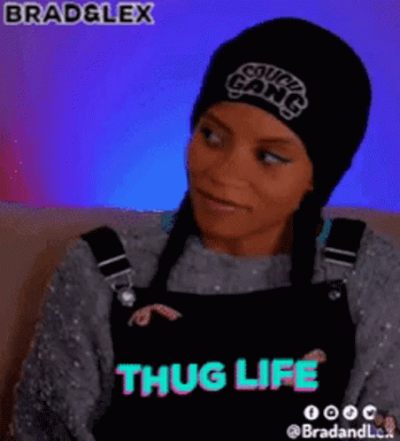 A Woman Wearing A Beanie And Overalls With The Words Thug Life On The Bottom GIF