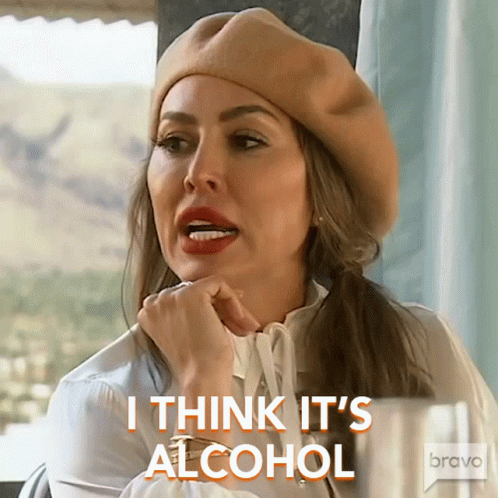 A Woman Wearing A Beret And A White Shirt Says I Think It 'S Alcohol GIF