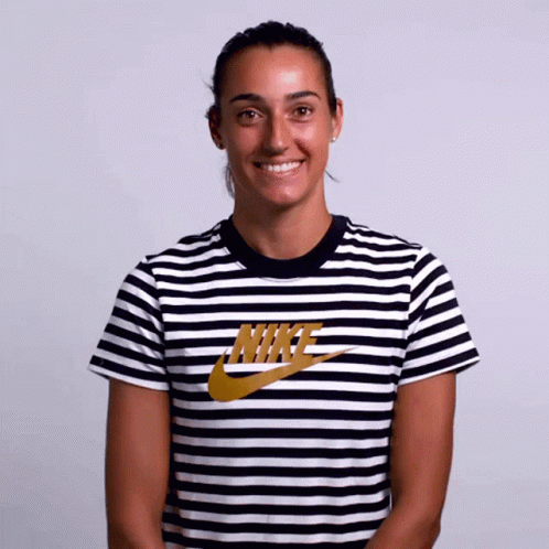 a woman wearing a black and white nike striped shirt