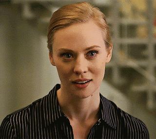 A Woman Wearing A Black And White Striped Shirt Smiles GIF