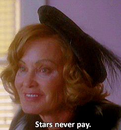 A Woman Wearing A Black Hat With The Words Stars Never Pay Below It GIF
