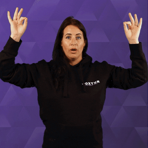 A Woman Wearing A Black Hoodie That Says Foxtur GIF