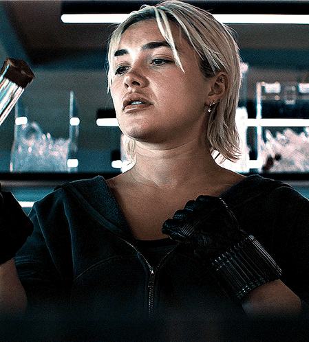 A Woman Wearing A Black Jacket And A Black Glove GIF