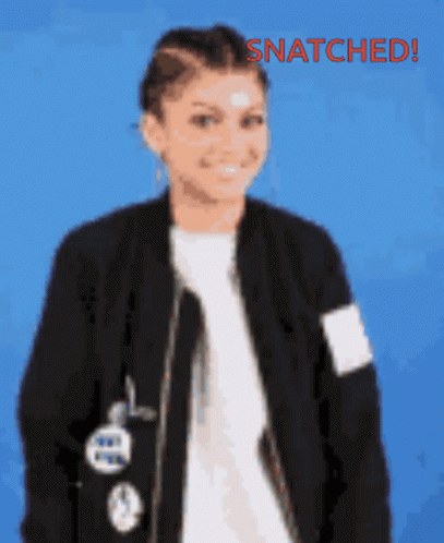 A Woman Wearing A Black Jacket And A White Shirt With The Words Snatched Written On The Bottom GIF