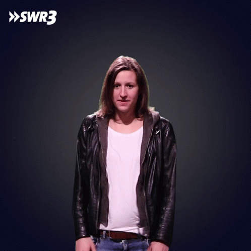 A Woman Wearing A Black Jacket Is Dancing In Front Of A Swr3 Sign GIF