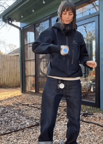 A Woman Wearing A Black Jacket That Says Arcteryx GIF
