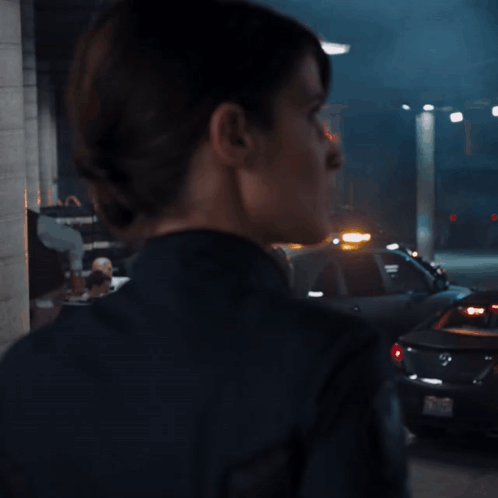 Woman In Black Jacket With Shield GIF