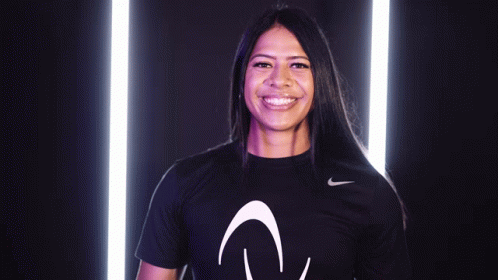 a woman wearing a black nike shirt with the letter v on it