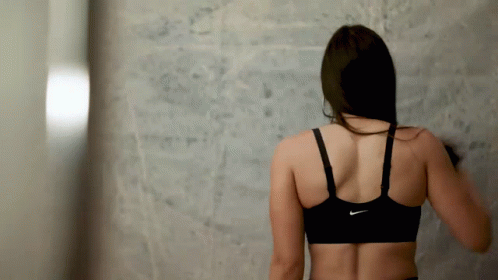 A Woman Wearing A Black Nike Sports Bra GIF