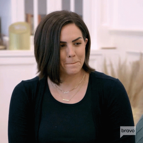 A Woman Wearing A Black Shirt And A Necklace With The Name Gabriela On It GIF