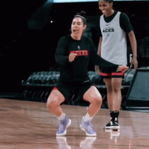 A Woman Wearing A Black Shirt That Says Aces On It GIF