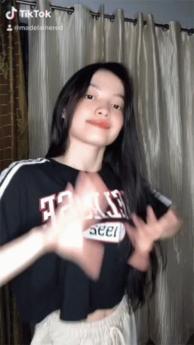 A Woman Wearing A Black Shirt That Says Texas GIF