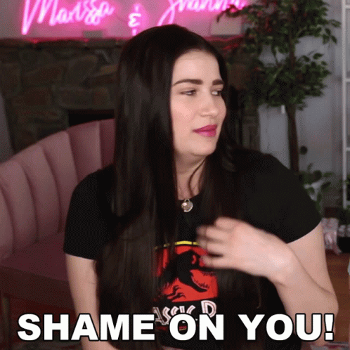 A Woman Wearing A Black Shirt With A Dinosaur On It Says " Shame On You " GIF