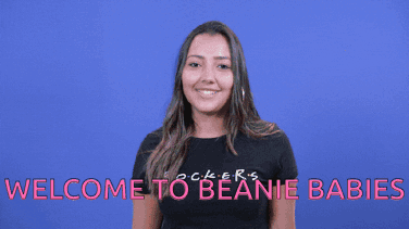 A Woman Wearing A Black Shirt With The Words Welcome To Beanie Babies GIF