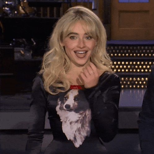 A Woman Wearing A Black Sweater With A Dog On It GIF