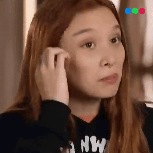A Woman Wearing A Black Sweatshirt With The Letter Nw On It GIF