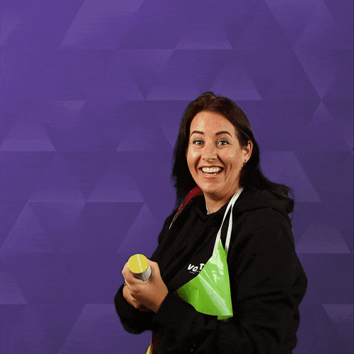 A Woman Wearing A Black Sweatshirt With The Word Vote On It GIF