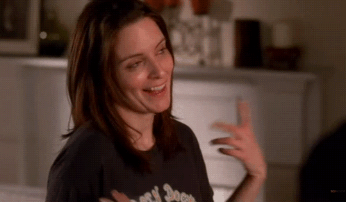 A Woman Wearing A Black T-Shirt That Says ' Rock N ' Roll ' On It GIF