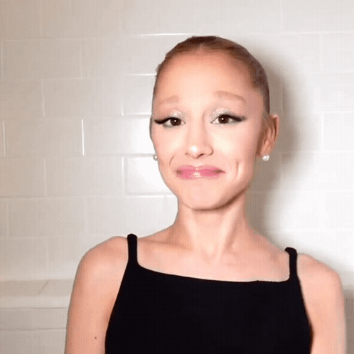 A Woman Wearing A Black Tank Top Making A Funny Face GIF