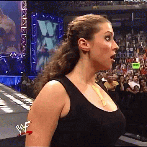 A Woman Wearing A Black Tank Top With A W On Her Arm GIF