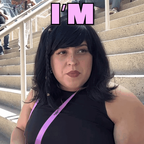 A Woman Wearing A Black Top And A Purple Lanyard With The Word I 'M On It GIF