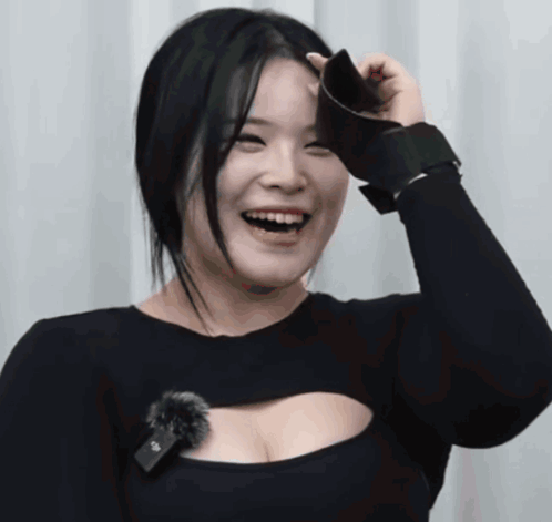 A Woman Wearing A Black Top With A Microphone On It GIF