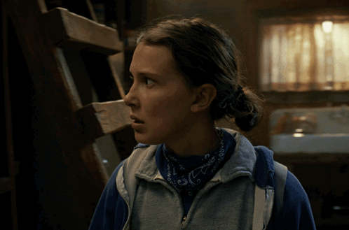 A Woman Wearing A Blue Bandana And A Sweatshirt With The Letter E On It GIF