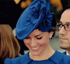 A Woman Wearing A Blue Hat And A Blue Dress GIF