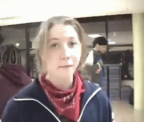 A Woman Wearing A Blue Jacket And A Red Scarf GIF
