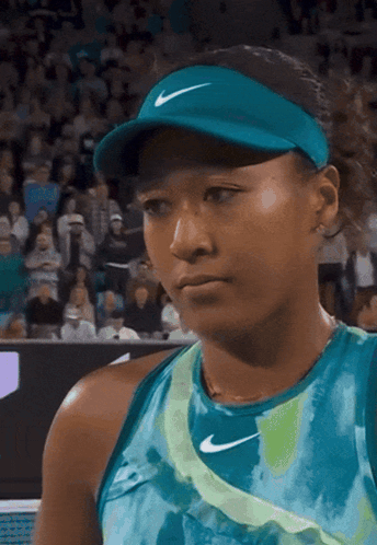 A Woman Wearing A Blue Nike Hat And A Blue Shirt GIF