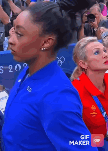 A Woman Wearing A Blue Nike Jacket With Usa On It GIF