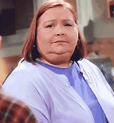 A Woman Wearing A Blue Shirt And A Blue Cardigan GIF
