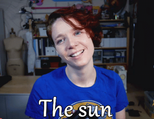 A Woman Wearing A Blue Shirt Says The Sun GIF