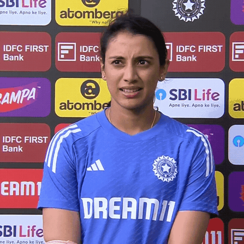 A Woman Wearing A Blue Shirt That Says Dream11 On It GIF